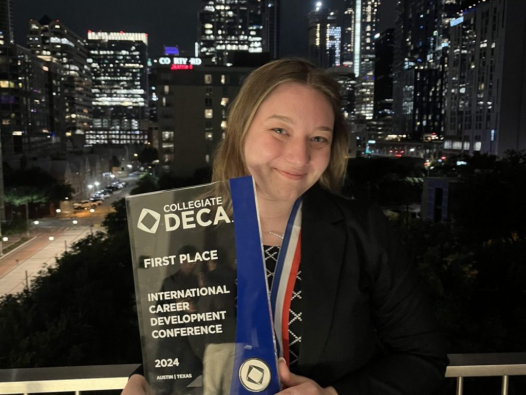 Tia DiMicelli holding up 1st place in Marketing Management